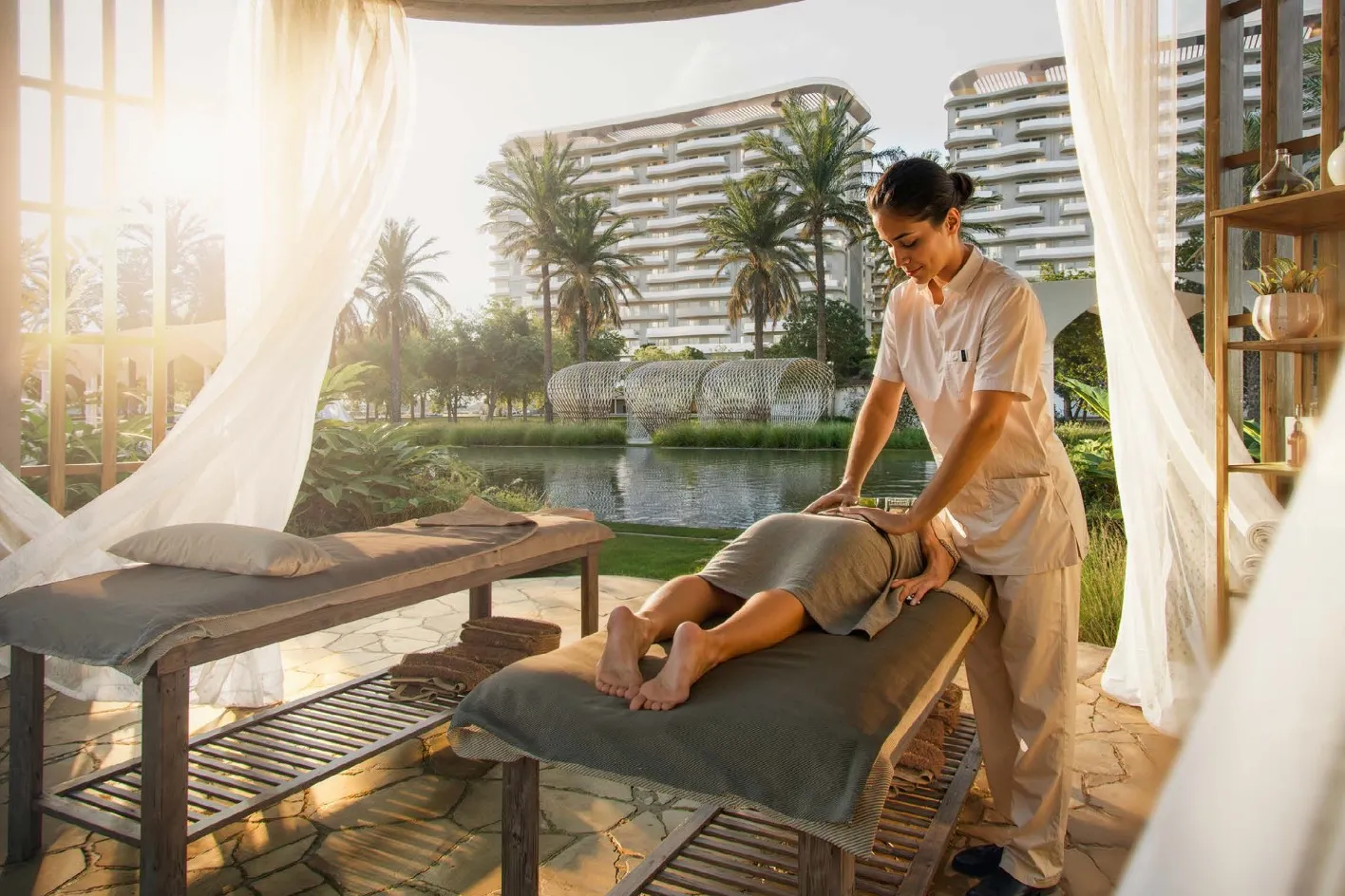 Massage beds under draped cabana beside the water