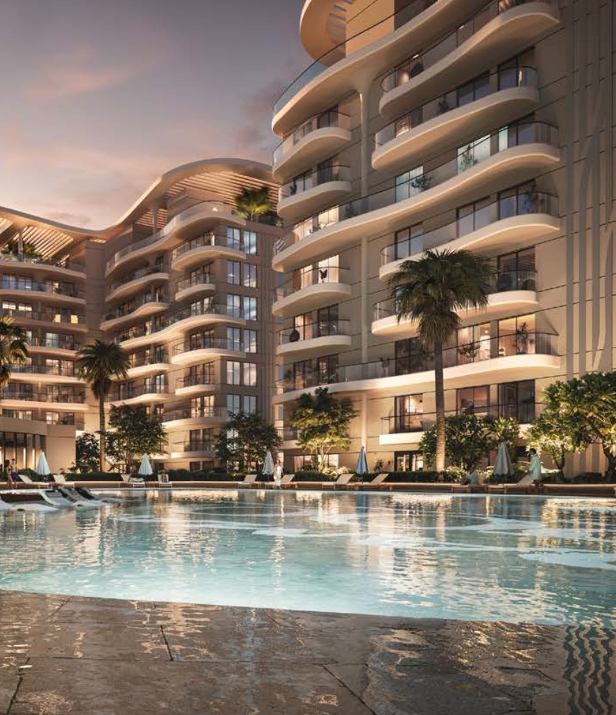 Curved balconies of Sorrento towers above a pool at dusk